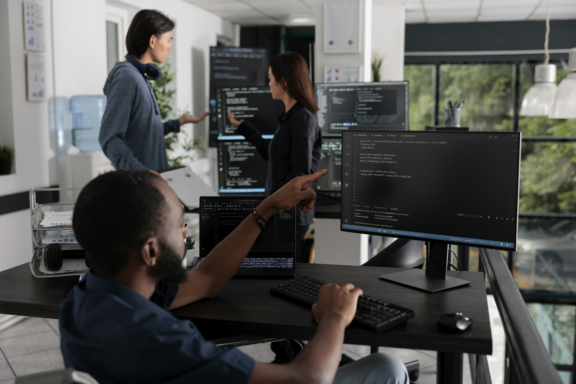 African american web developer in wheelchair looking at programming languag